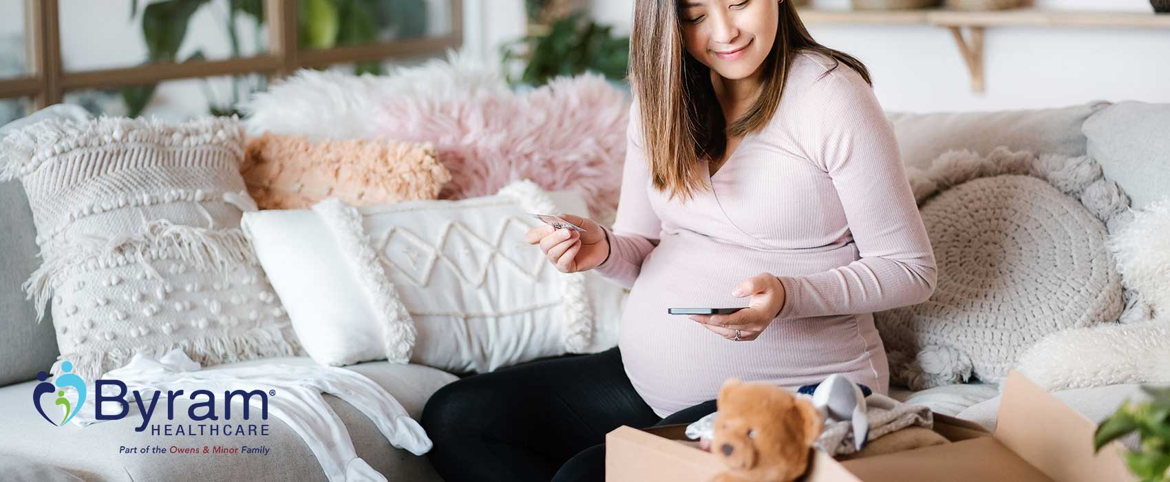 Pregnant woman looking a baby gifts.