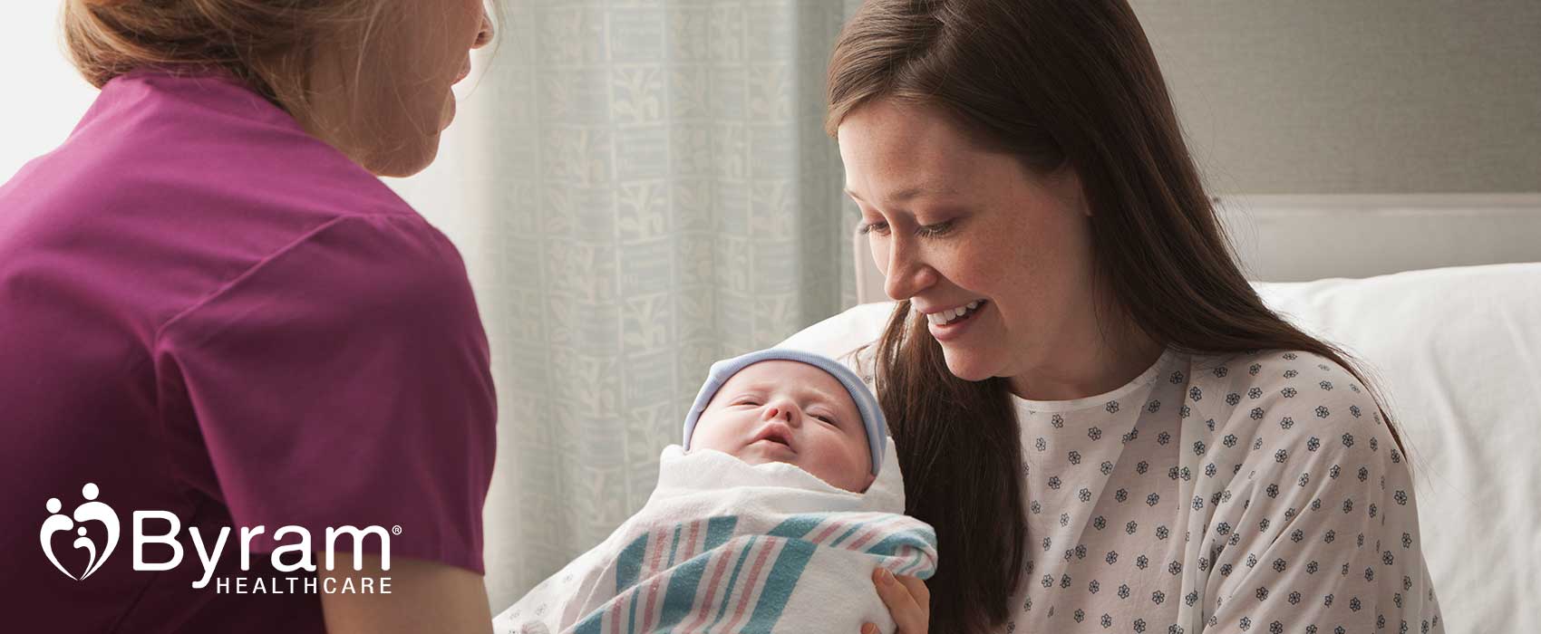 Nurse handing a newborn to a mom,