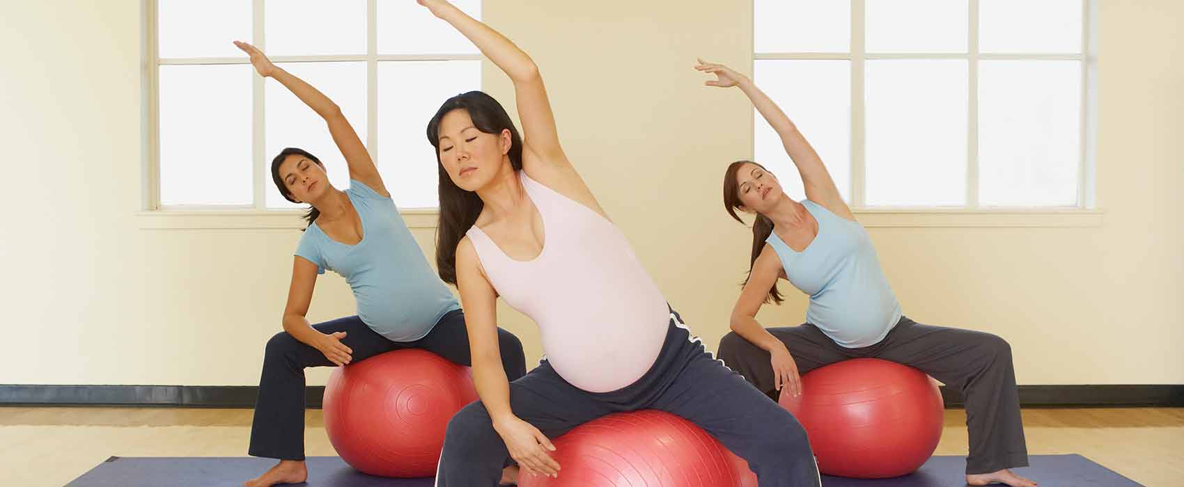 Pregnant woman stretching at a birthing class